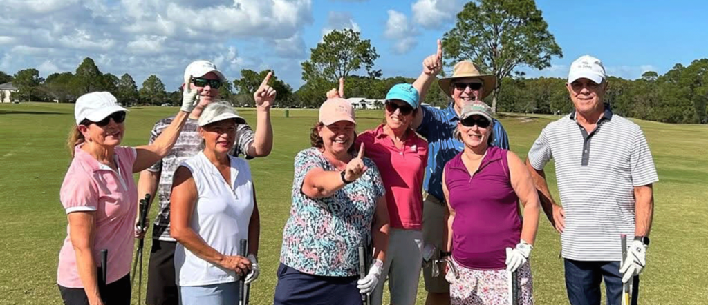 Golfers raising their hands displaying they're number 1!